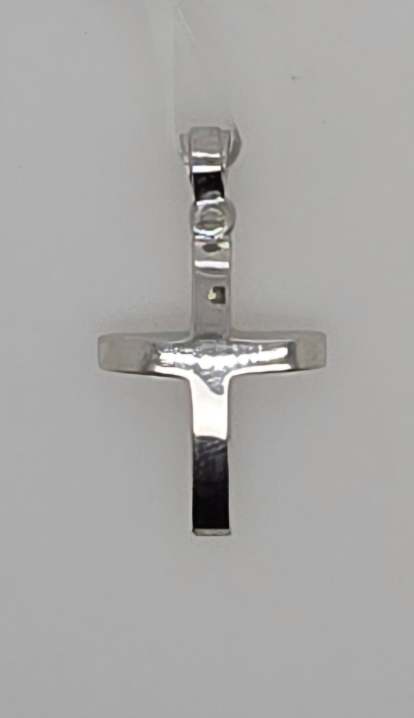 9CT WHITE GOLD IMPORTED POLISHED WITH SLIGHT CURVE CROSS PENDANT.
