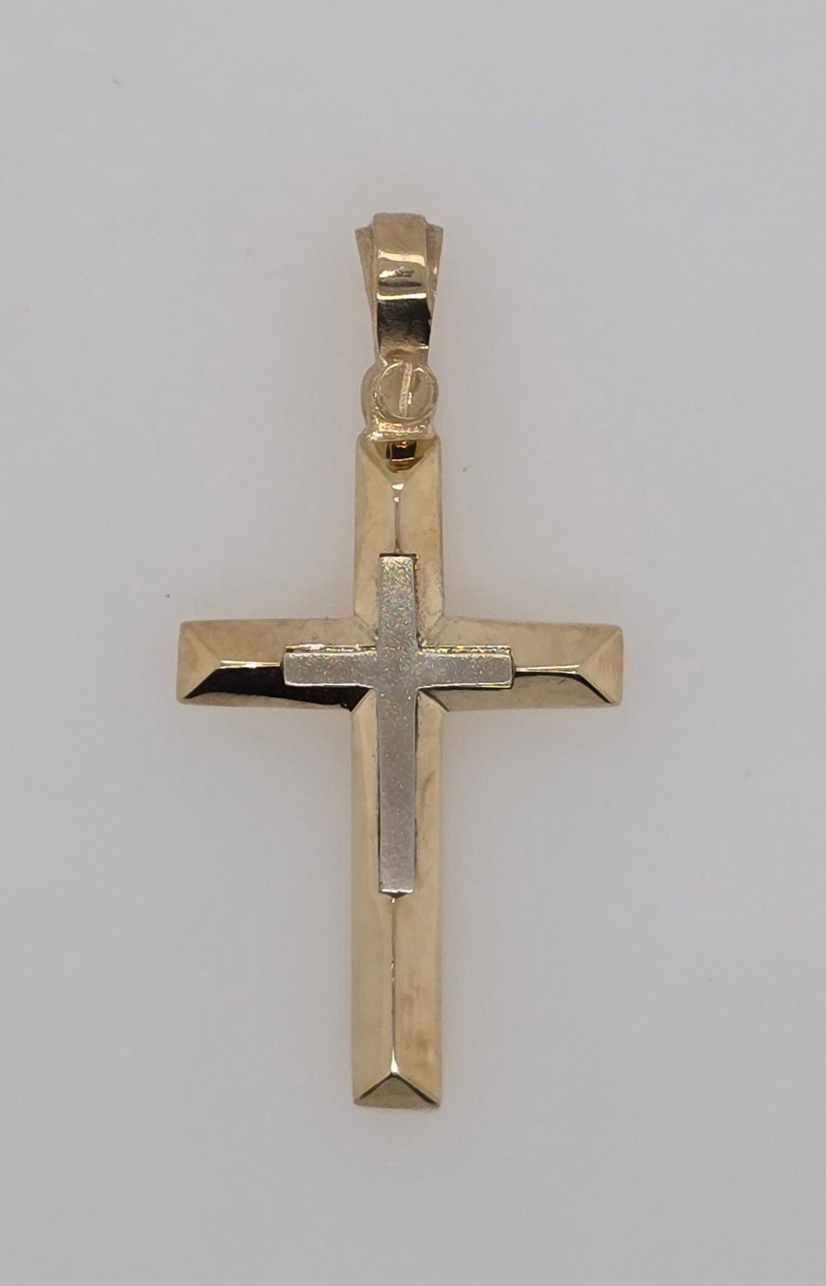 9CT TWO TONE IMPORTED CROSS WITH WHITE GOLD RAISED CENTER.