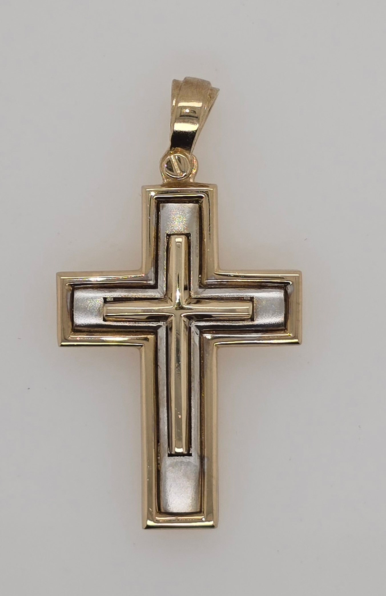 9CT TWO TONE IMPORTED LARGE CROSS WITH YELLOW GOLD RAISED CENTER.