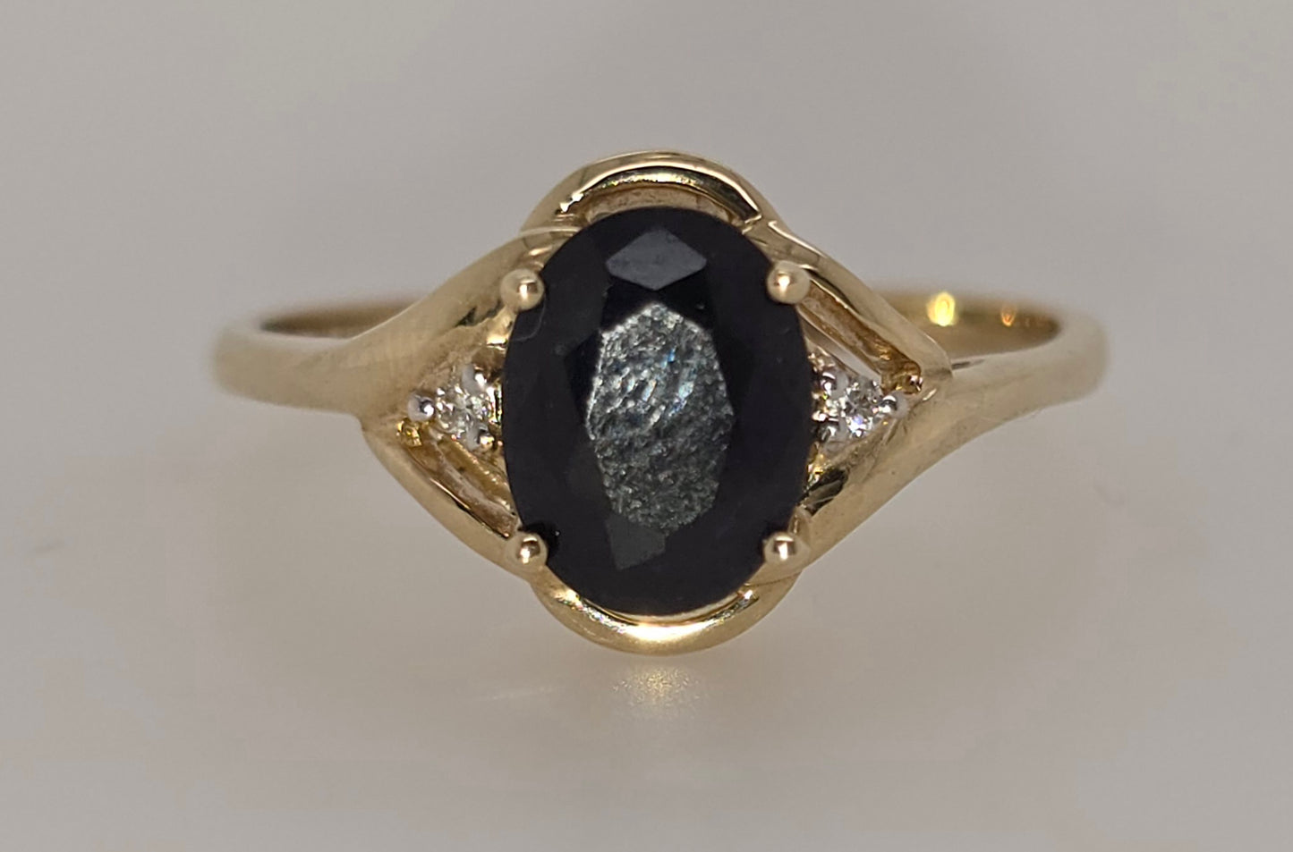 9CT YELLOW GOLD AUSTRALIAN 8MM X 6MM OVAL SAPPHIRE AND DIAMOND RING.
