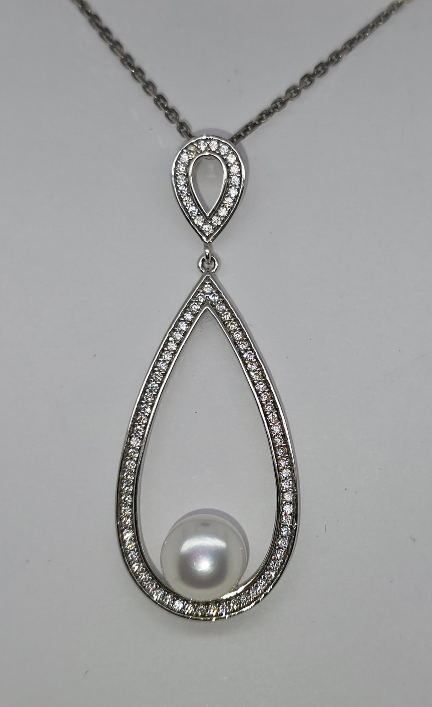 STERLING SILVER FRESHWATER PEARL CUBIC ZIRCONIA TEARDROP NECKLACE.
