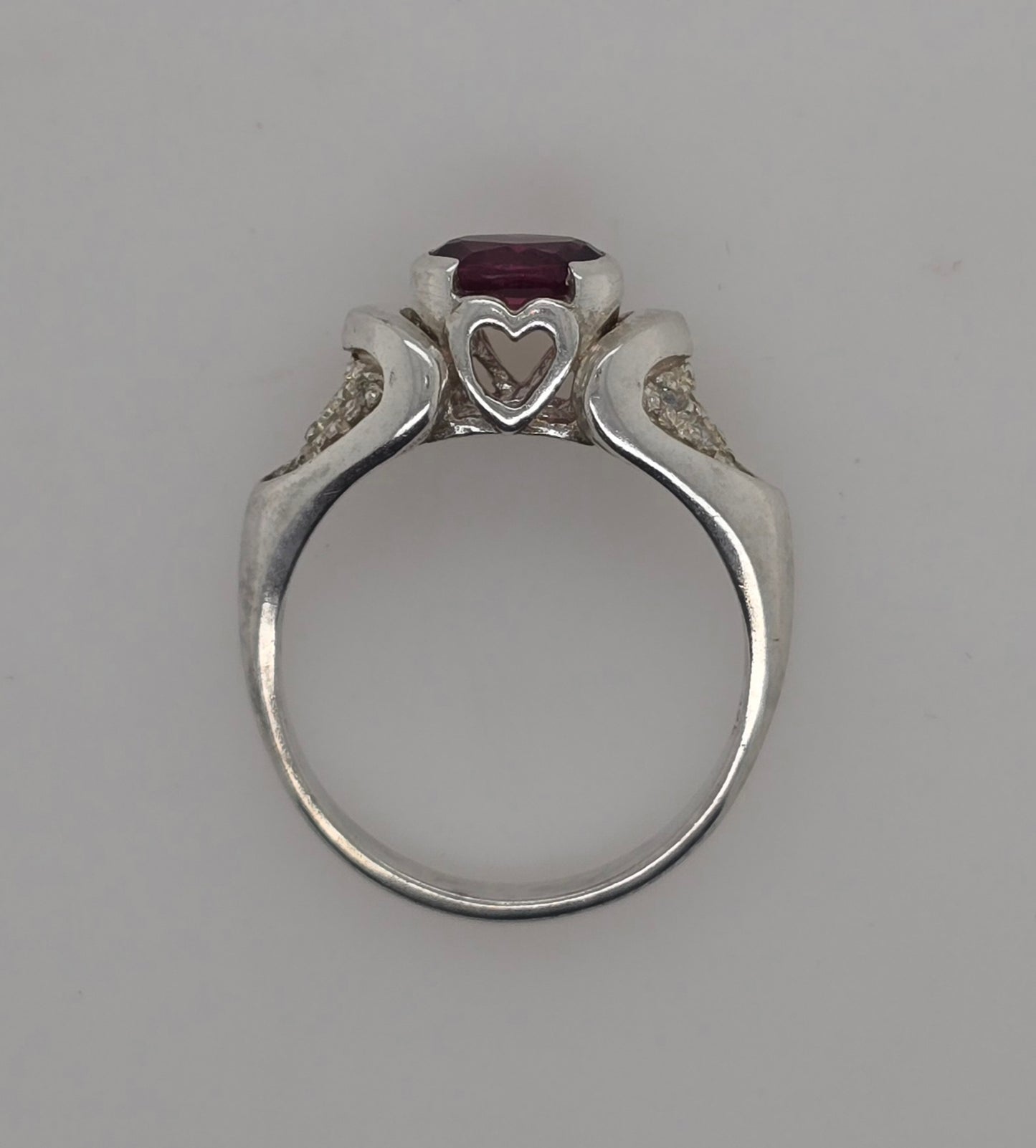STERLING SILVER SEMI BEZEL SET 7 X 5 OVAL GARNET RING.