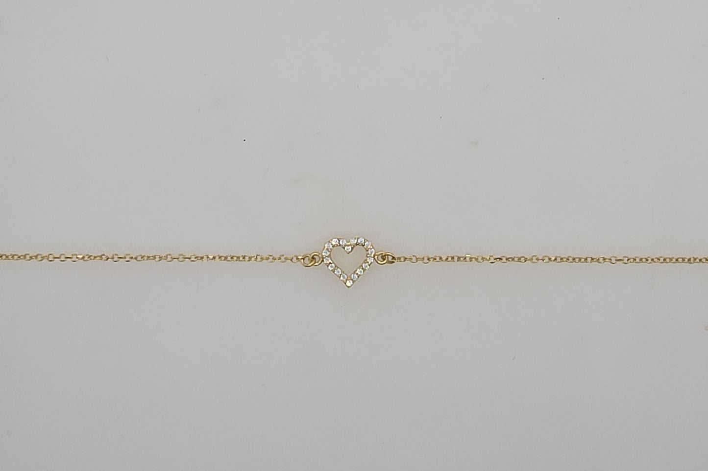 9CT YELLOW GOLD IMPORTED CUBIC ZIRCONIA 7.5MM OPEN HEART BRACELET.