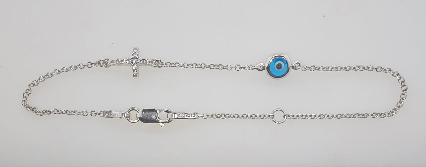 9CT WHITE GOLD CUBIC ZIRCONIA CROSS AND EVIL EYE BRACELET.