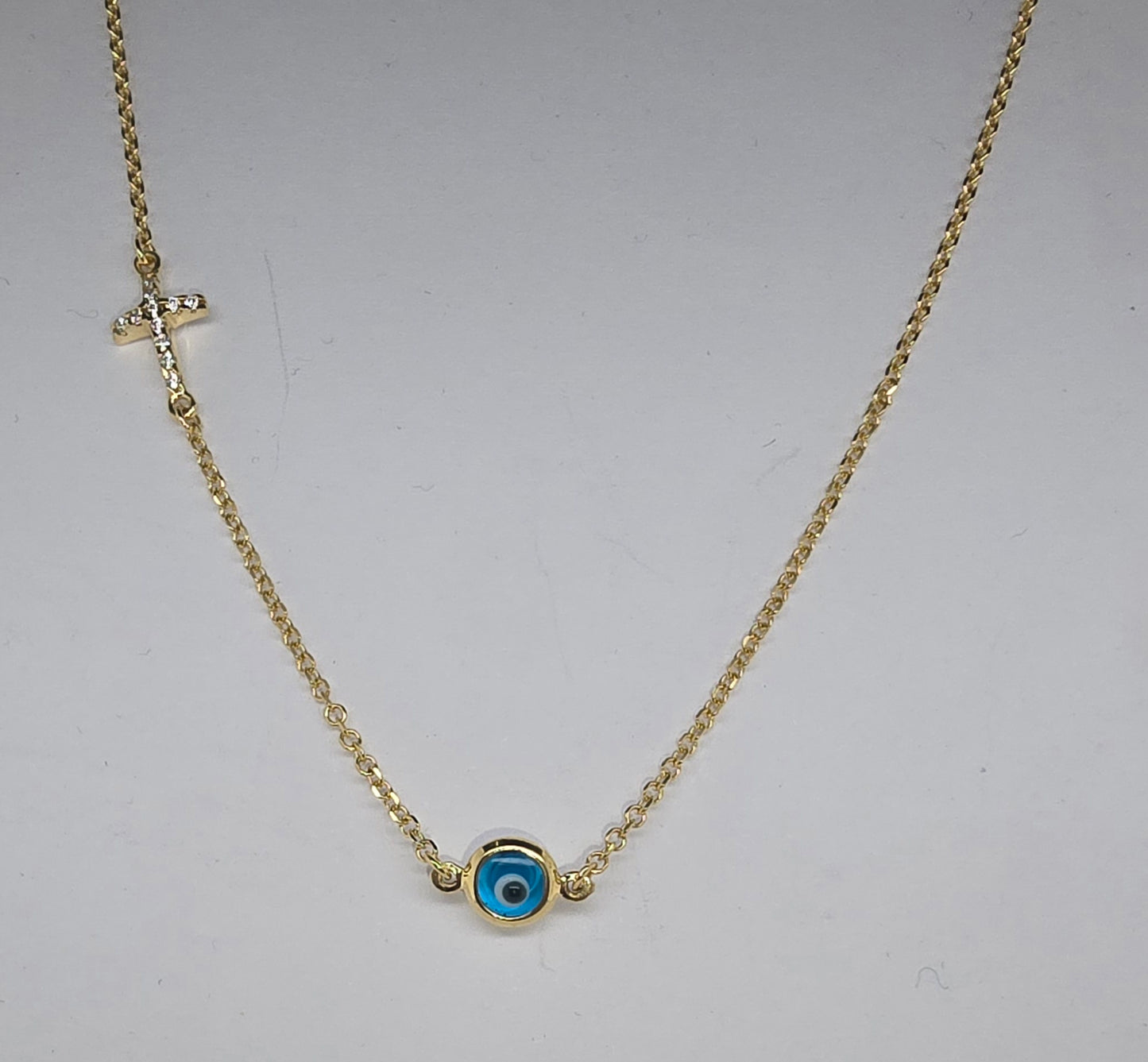 9CT YELLOW GOLD CHAIN WITH EVIL EYE AND CUBIC ZIRCONIA CROSS NECKLACE.