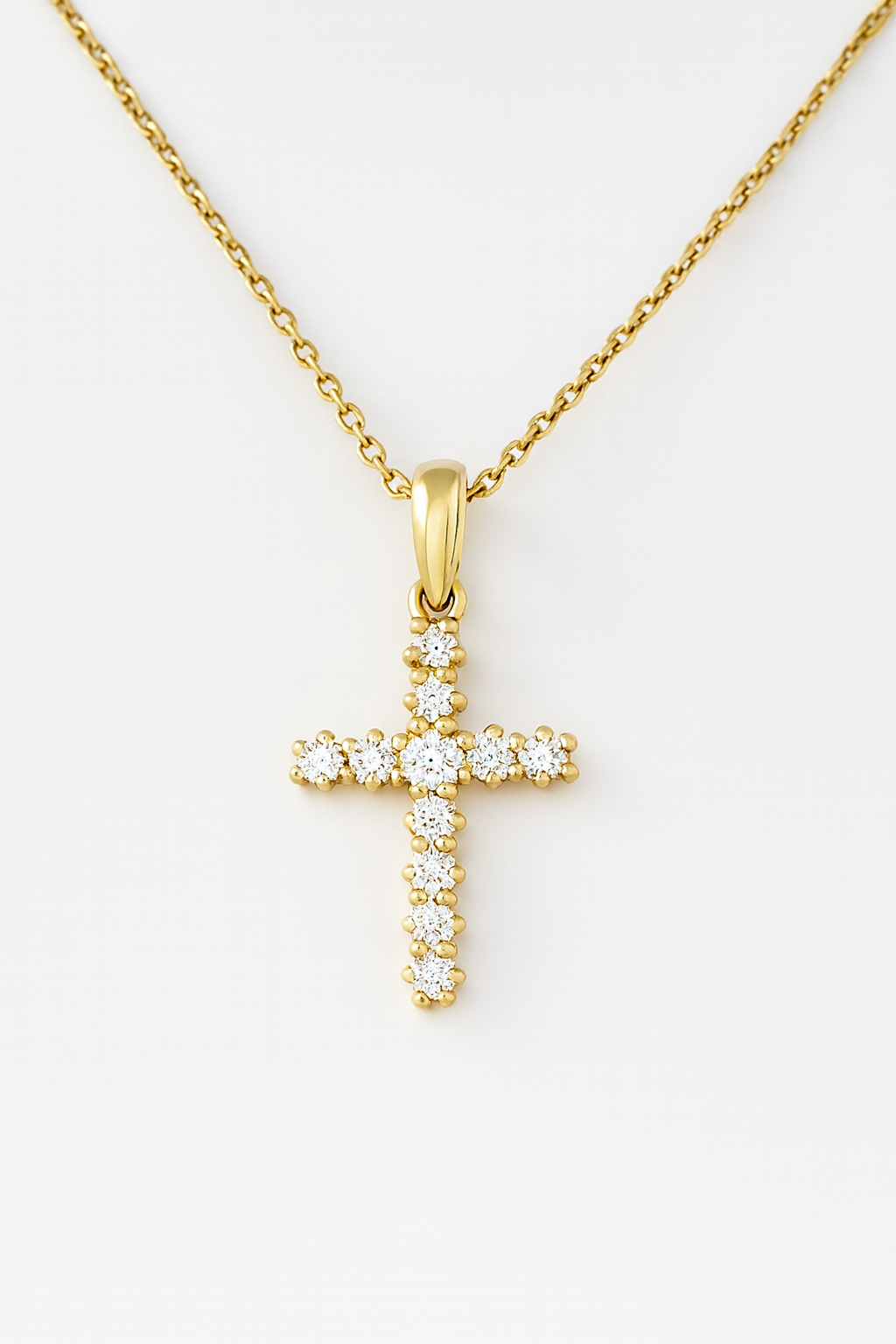18CT YELLOW GOLD CLAW SET DIAMOND CROSS.