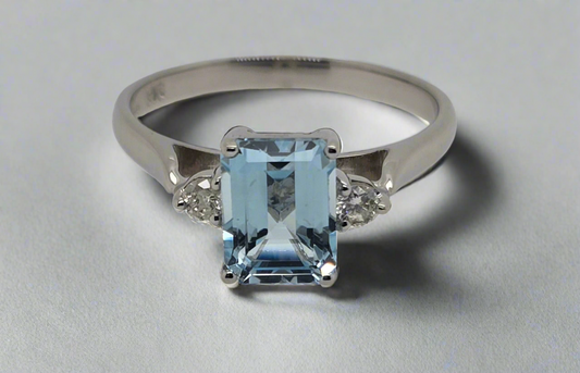 9CT WHITE GOLD 8 X 6MM EMARALD CUT BLUE TOPAZ AND DIAMOND RING