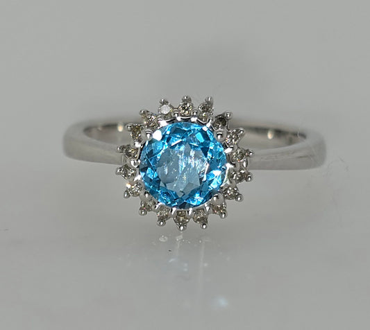 9CT WHITE GOLD BLUE TOPAZ AND DIAMOND HALO RING.