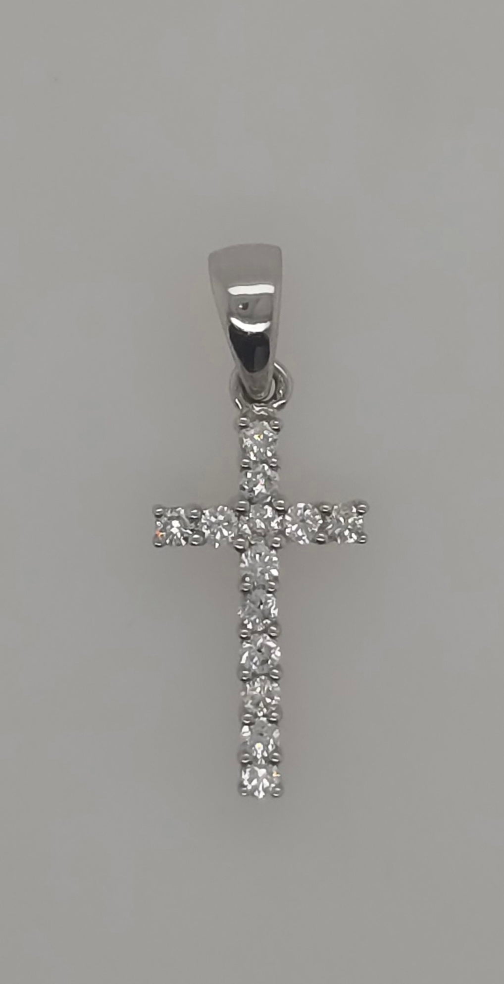 18CT WHITE GOLD SMALL DIAMOND CROSS.