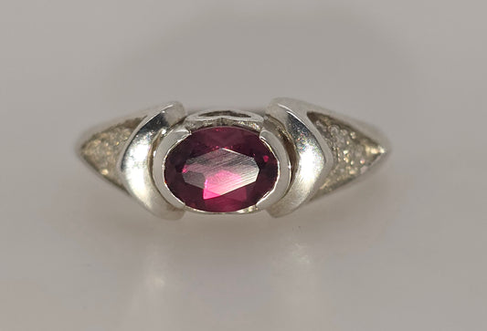 STERLING SILVER SEMI BEZEL SET 7 X 5 OVAL GARNET RING.