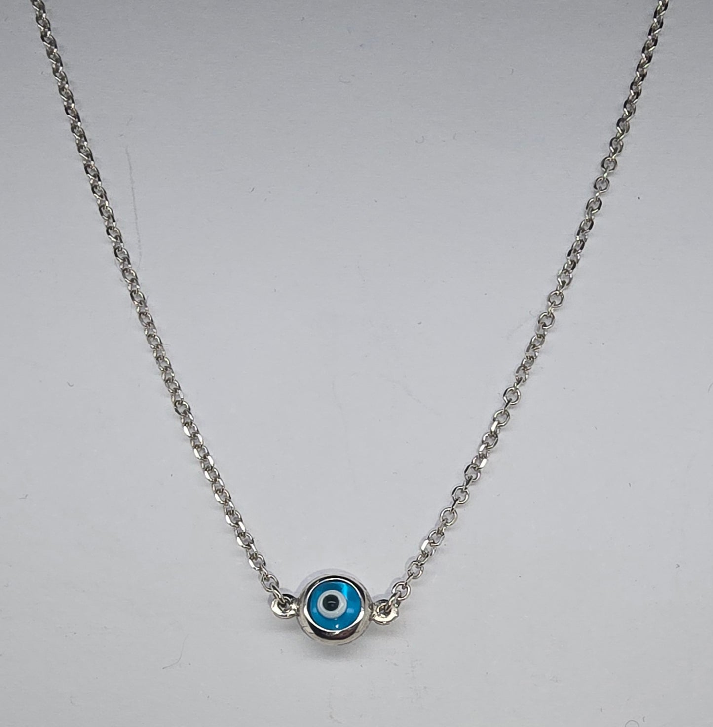 9CT WHITE GOLD IMPORTED 43CM TRACE CHAIN WITH 5.7MM EVIL EYE.