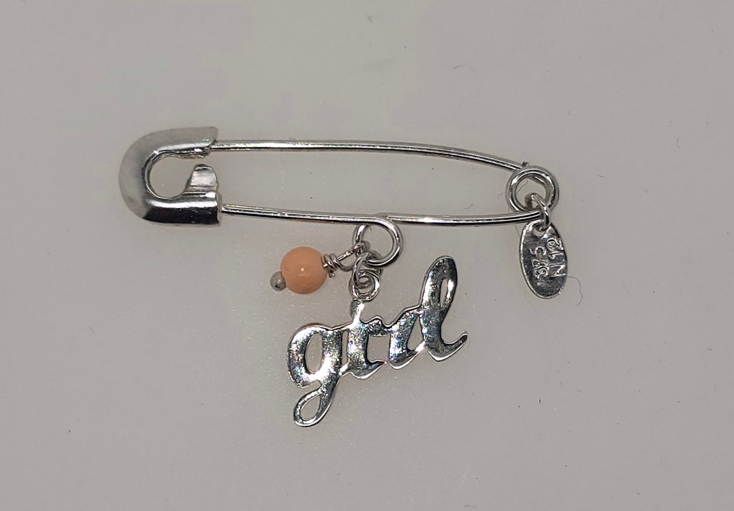 9CT WHITE GOLD IMPORTED BABY PIN WITH PINK BEAD AND GIRL CHARM