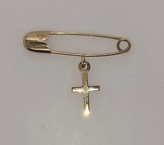 9CT YELLOW GOLD IMPORTED SAFETY PIN WITH CROSS CHARM.