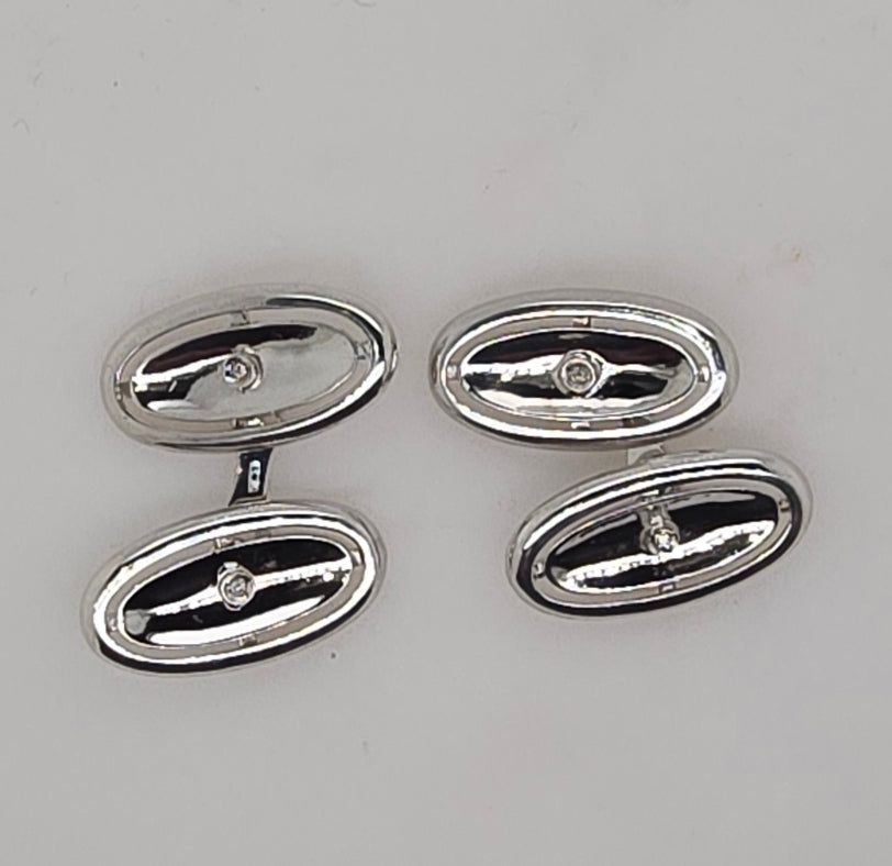 18CT WHITE GOLD IMPORTED OVAL CUFF LINKS SET WITH DIAMONDS.