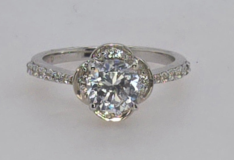 STERLING SILVER RING WITH 6MM ROUND CUBIC ZIRCONIA CENTER.