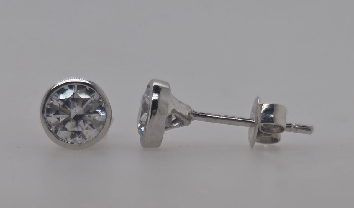 9CT WHITE GOLD BEZEL SET 5MM ROUND CUBIC ZIRCONIA STUD EARRINGS.