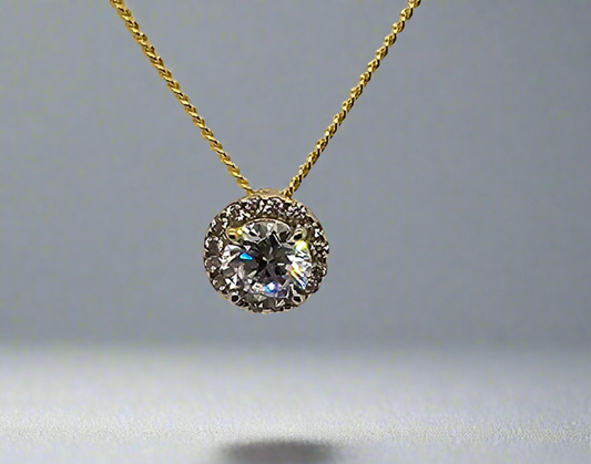 9CT YELLOW GOLD CUBIC ZIRCONIA HALO ROUND PENDANT.