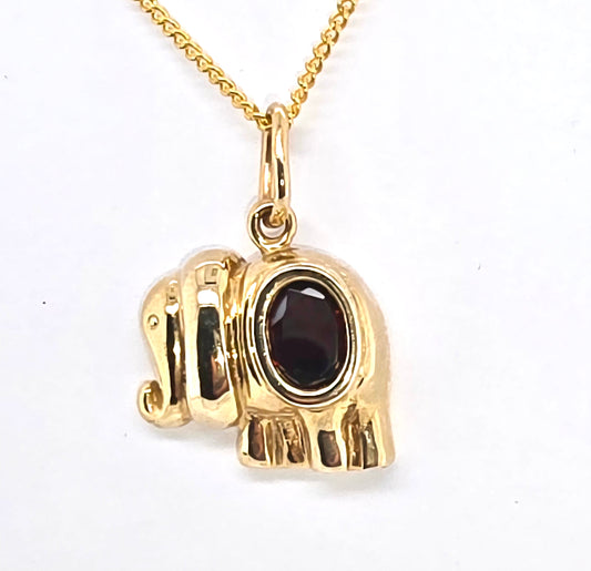 9CT YELLOW GOLD ELEPHANT PENDANT WITH BEZEL SET 8 X 6MM OVAL GARNET.