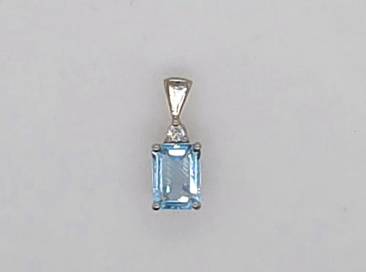 9CT WHITE GOLD 8 X 6MM EMERALD CUT BLUE TOPAZ AND DIAMOND PENDANT.