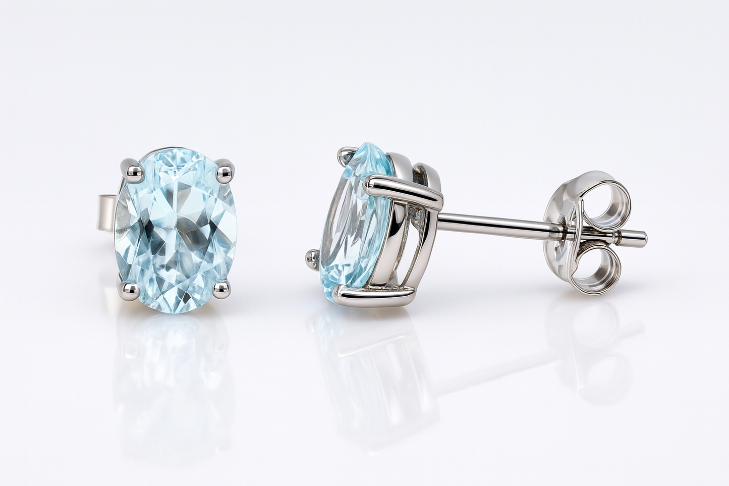 9CT WHITE GOLD 4 CLAW SET 8X6MM OVAL AQUAMARINE STUD EARRINGS.