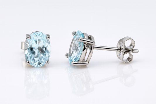 9CT WHITE GOLD 4 CLAW SET 8X6MM OVAL AQUAMARINE STUD EARRINGS.
