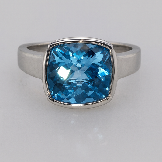 9CT WHITE GOLD BEZEL SET BLUE TOPAZ 9MM CUSHION CUT RING.