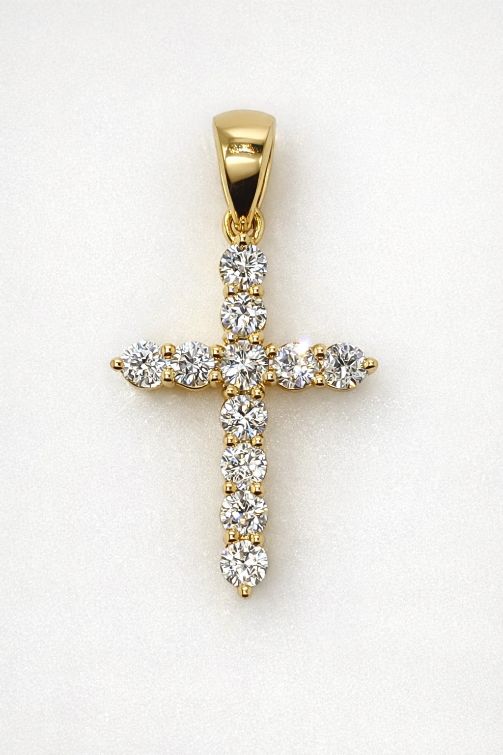 18CT YELLOW GOLD DIAMOND CLAW SET CROSS PENDANT.