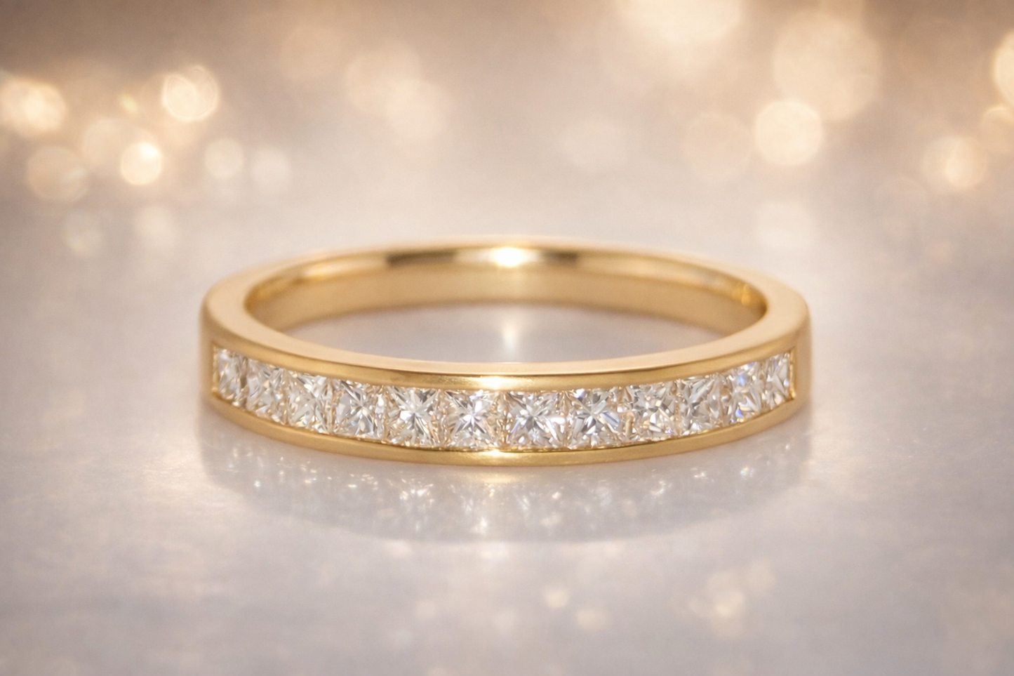 18CT YELLOW GOLD CHANNEL SET DIAMOND RING.