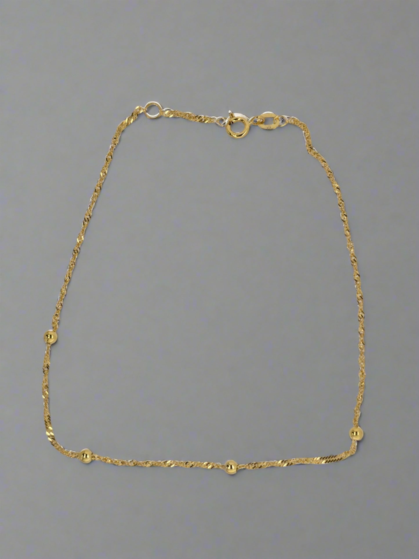 9CT YELLOW GOLD 24CM TWIST AND BALL ANKLET.