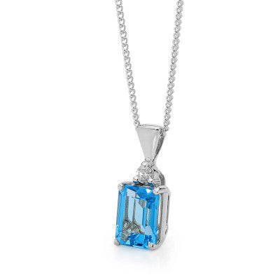 9CT WHITE GOLD 8 X 6MM EMERALD CUT BLUE TOPAZ AND DIAMOND PENDANT.