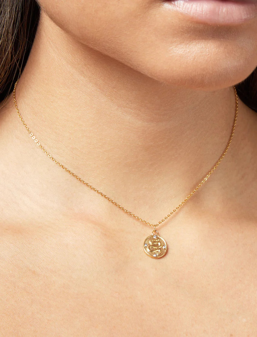 PASTICHE STAINLESS STEEL GOLD PLATED ERIS NECKLACE WITH SNAKE AND CUBIC ZIRCONIA OVAL PENDANT